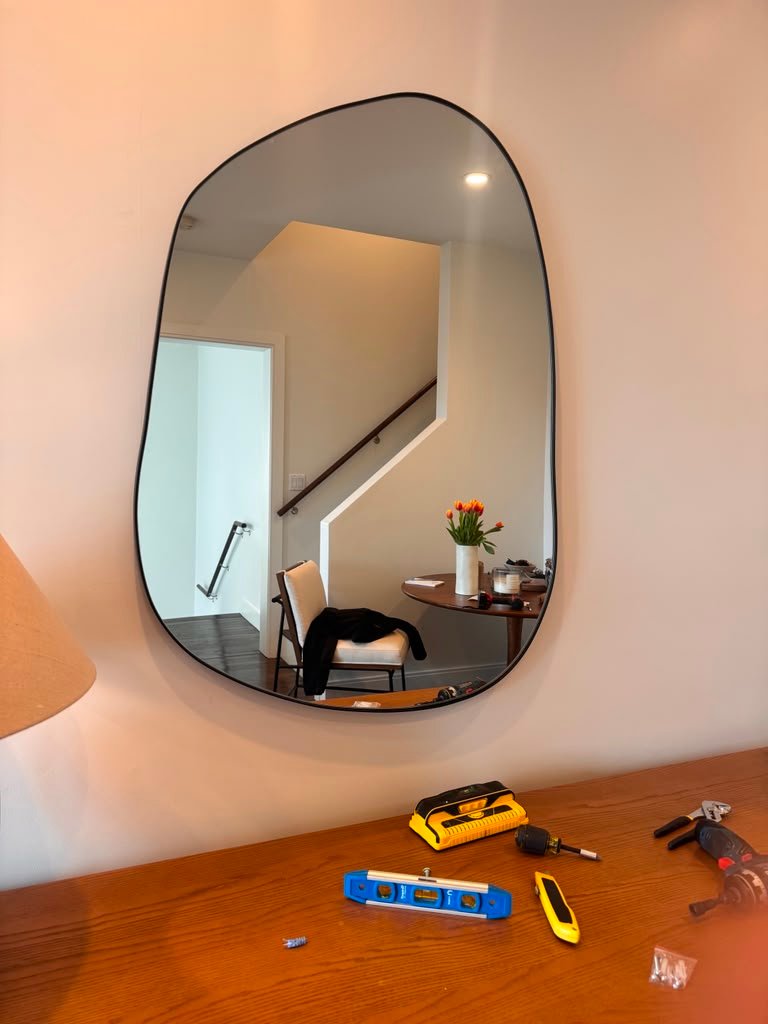 Large rounded mirror installation