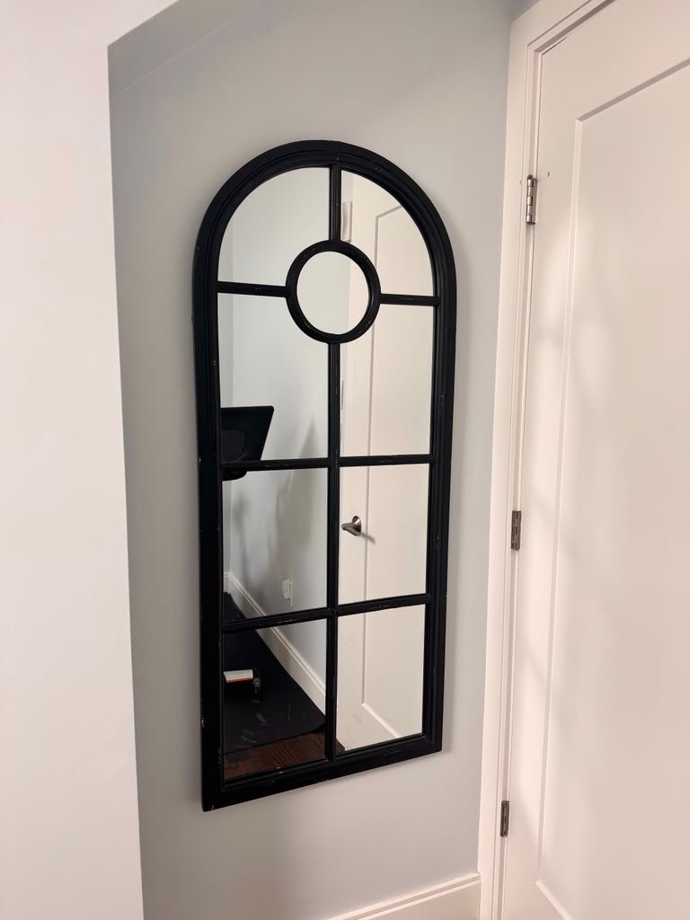 Black arched mirror installation