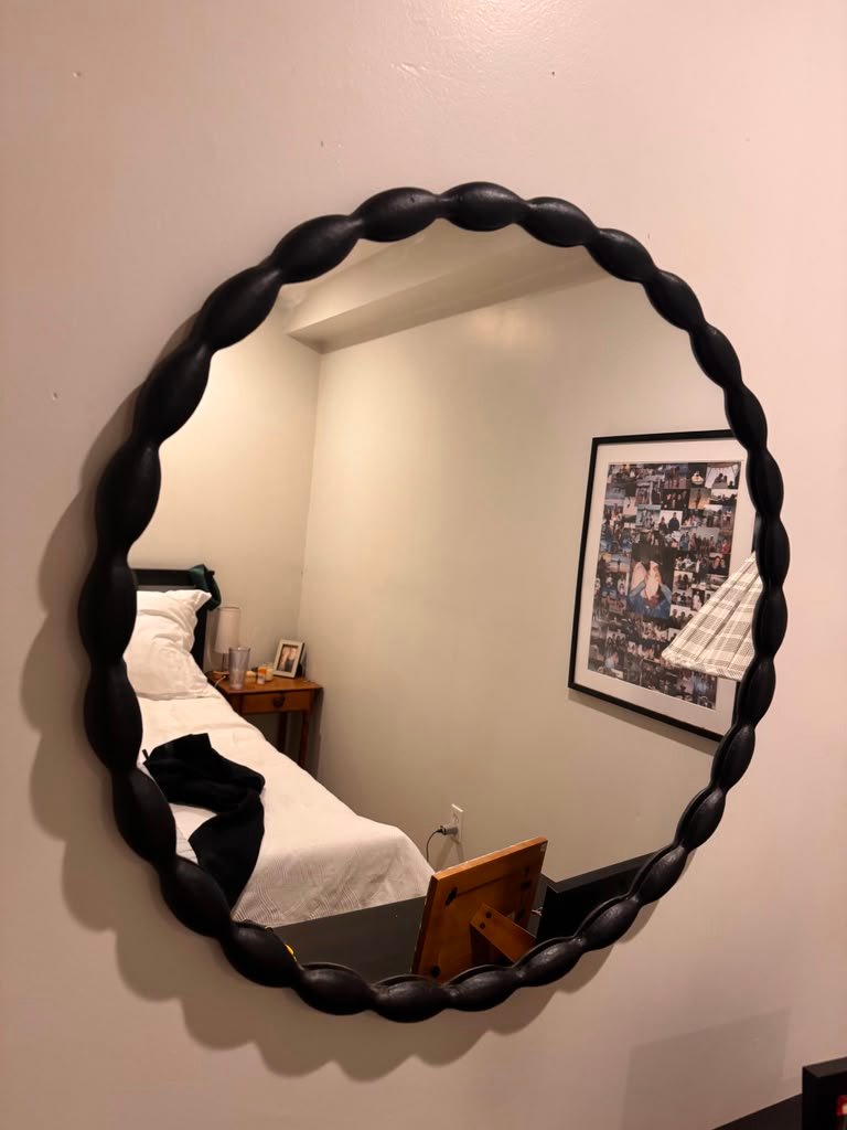 Black round mirror installation