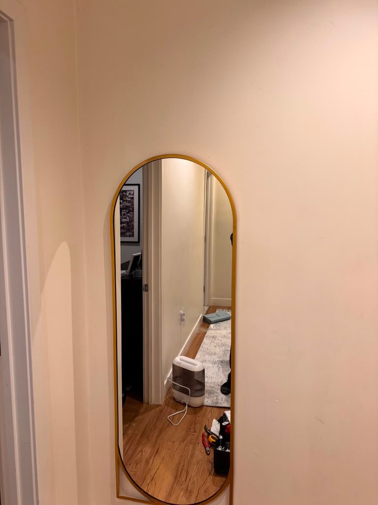 Gold arched mirror installation