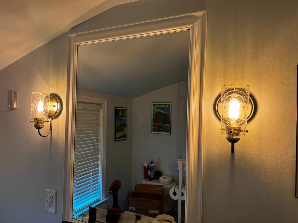 Framed bathroom mirror installation with lights