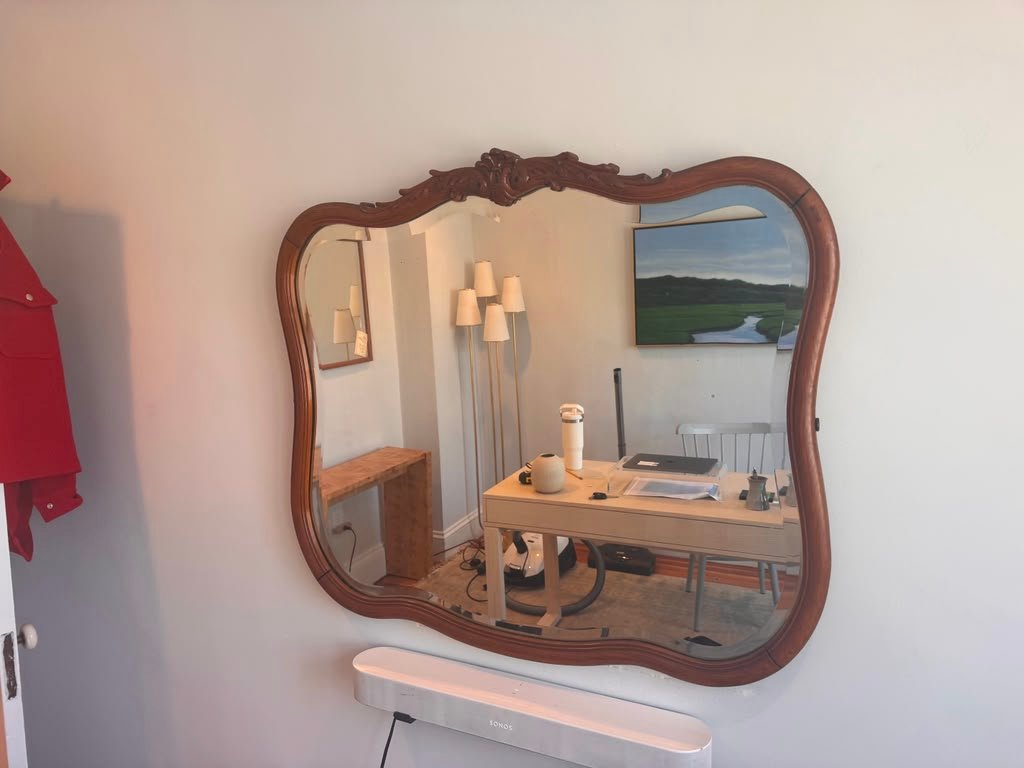 Wood framed mirror installation