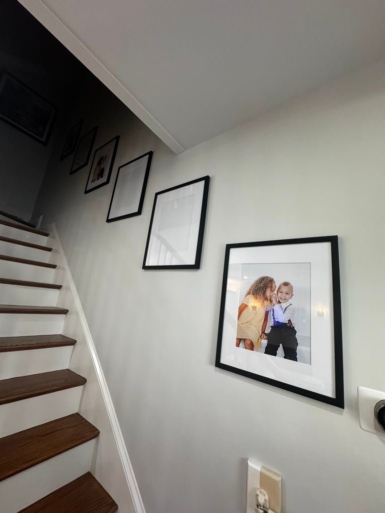 Stairway picture hanging gallery wall