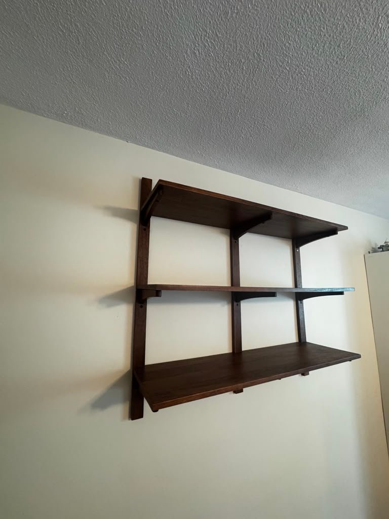 Large dark wood wall shelf installation