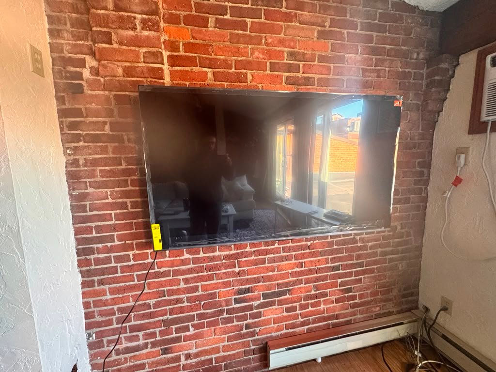 TV mounted on brick wall