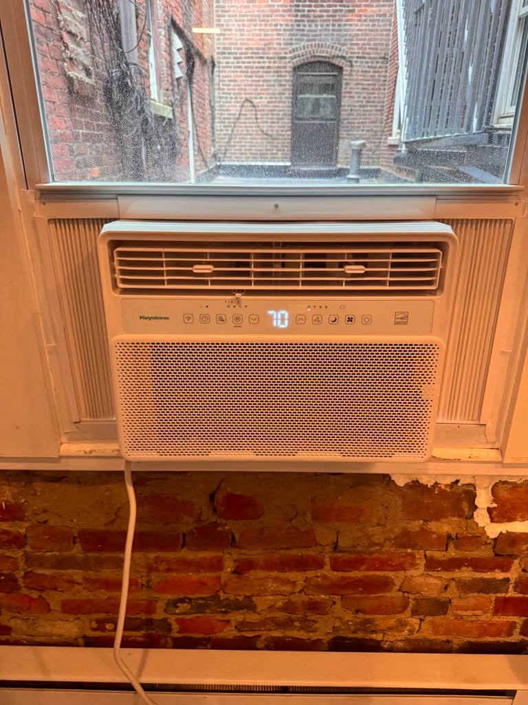Keystone window AC installation with brick wall